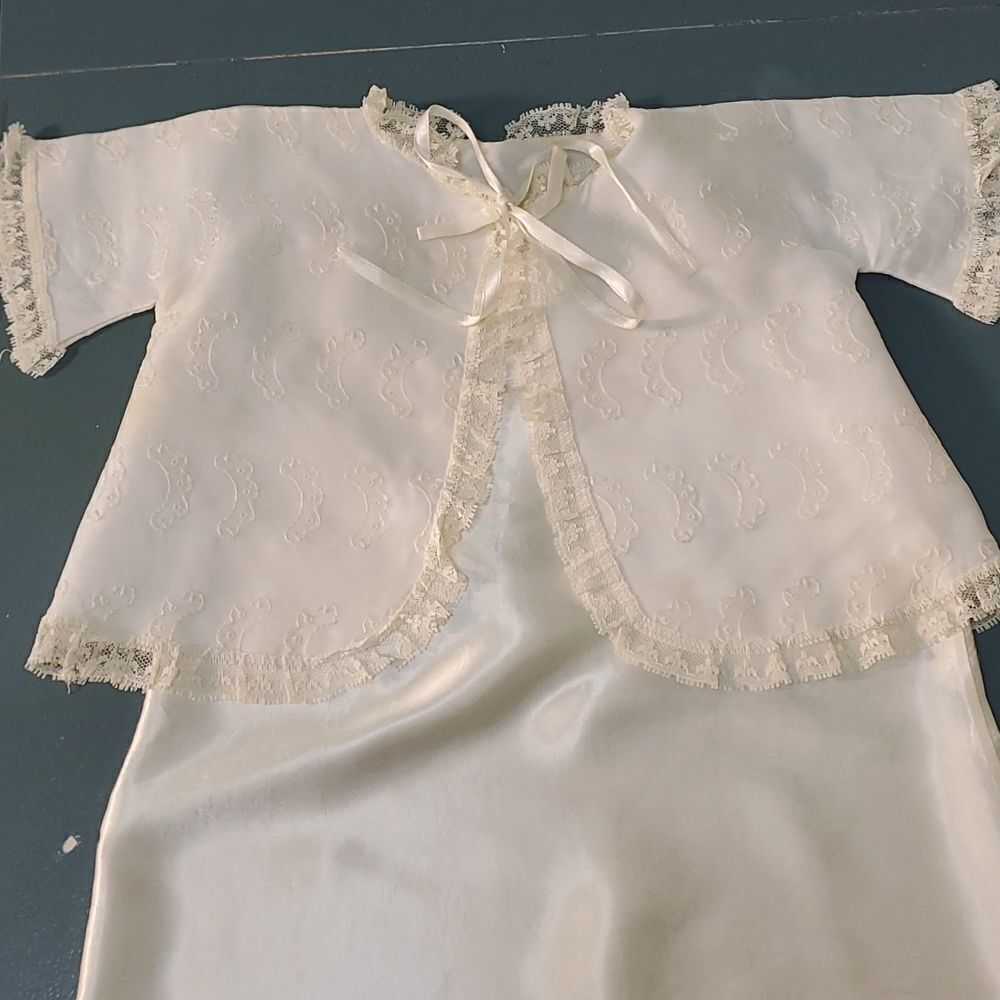 Vintage baby dress with jacket. Trimmed in lace with tie. The jacket has enbroid